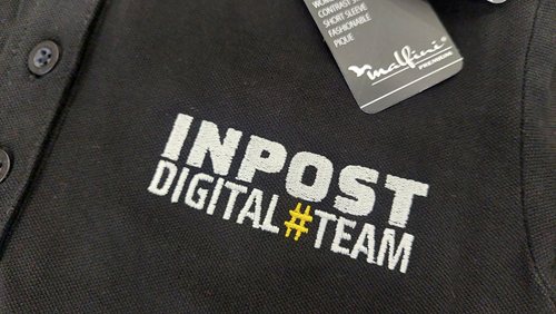 Zbliżenie haftowanego logo InPost na koszulce polo